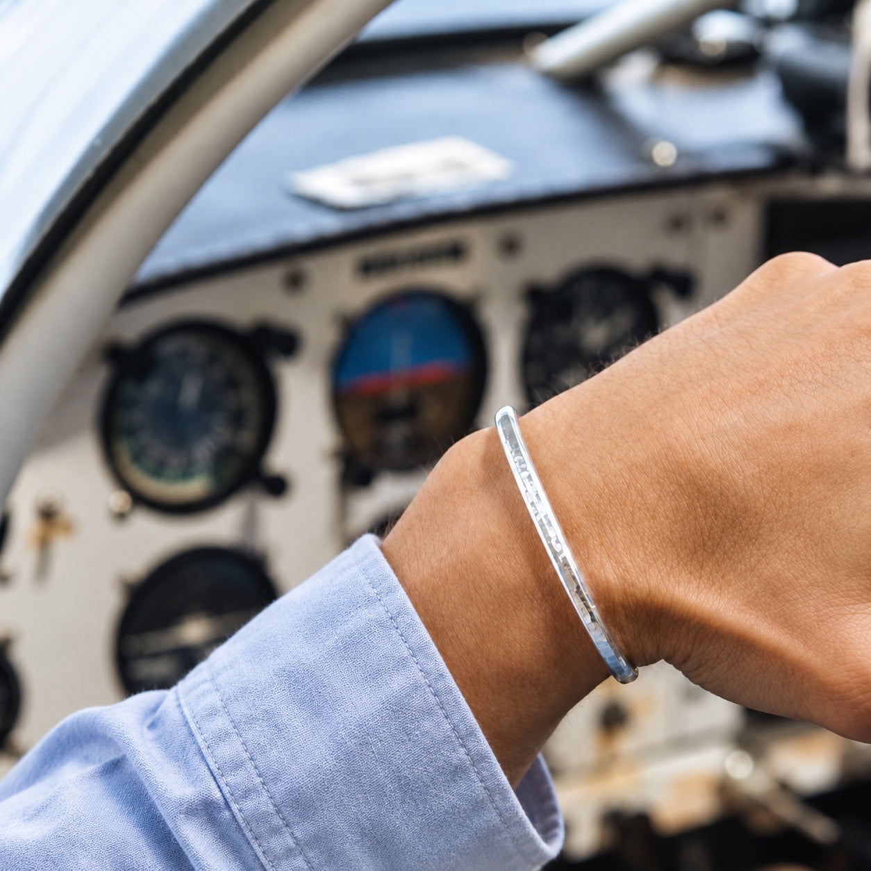 SkyBolt one-ounce fine silver cuff worn in an aircraft cockpit