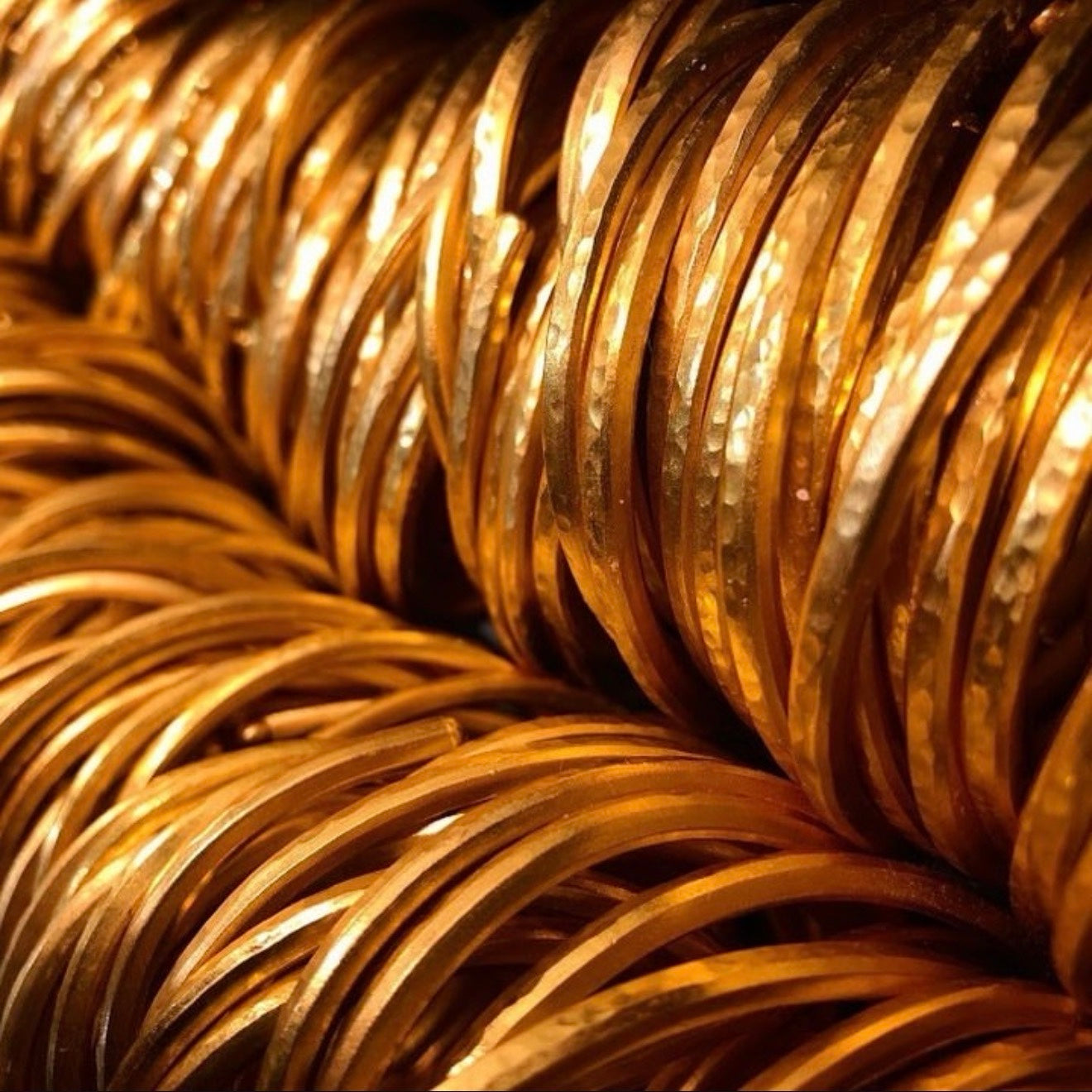 Original production photograph of gold cuffs from the SkyBolt makers