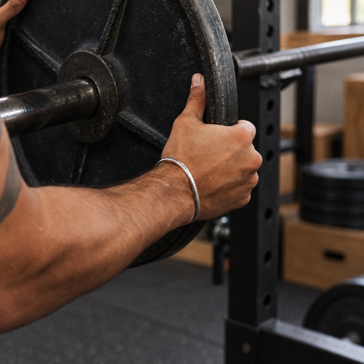 SkyBolt fine silver cuff worn while loading a barbell