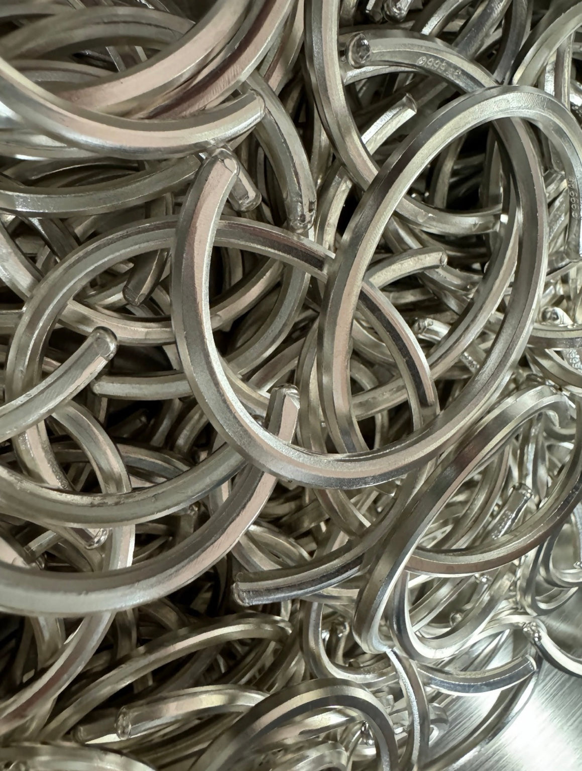 Original production photograph of a batch of silver cuffs